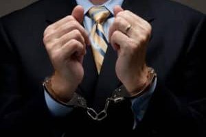 A Man Arrested Wearing A Suit And Tie