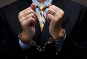 a man arrested wearing a suit and tie