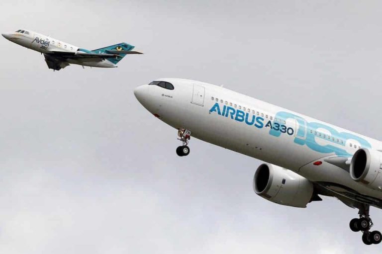 a large passenger jet flying through a cloudy blue sky