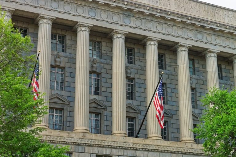 a large USA flag in front of a building