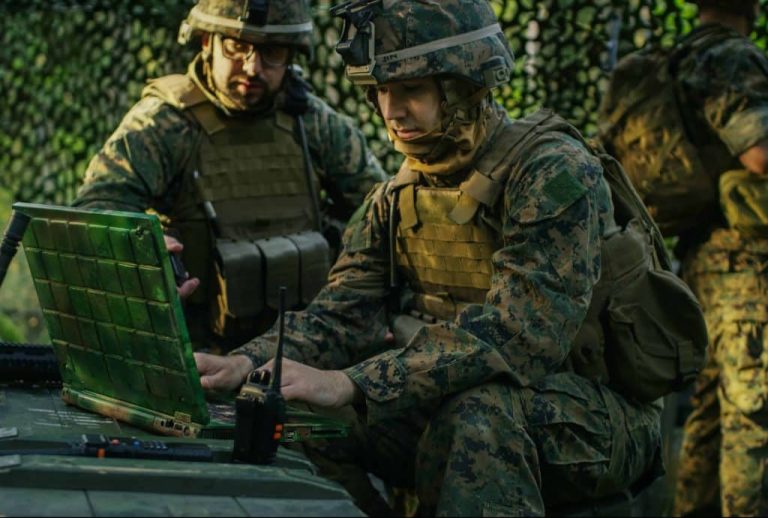 a man in a military uniform using a computer
