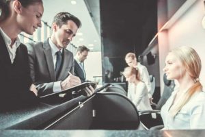 A Group Of People Sitting At A Desk