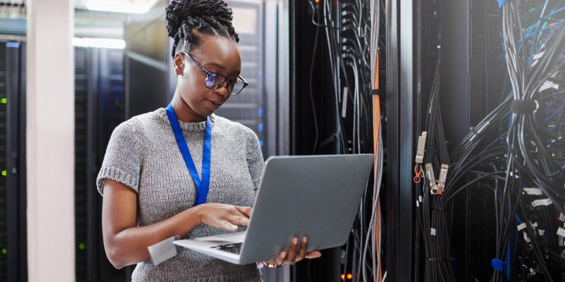 a person standing in front of a laptop a person standing in front of a laptop