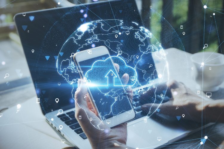 Cloud technology and storage concept with virtual world map model and cloud icon inside on man hand using smartphone and laptop background Kiosk-based access to a secure cloud environment, showing controlled data interaction across connected devices